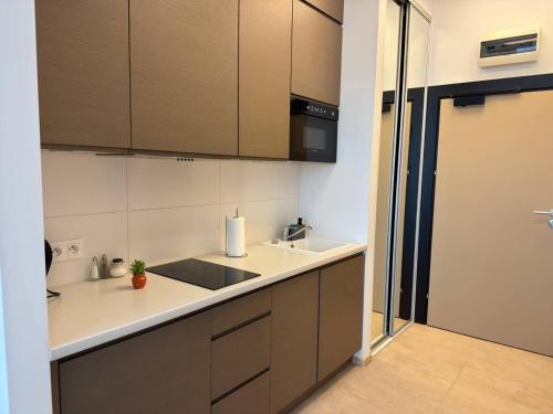 a kitchen with a sink and a counter top at Zlatarooms in Warsaw