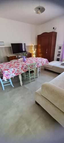 a living room with a table and a couch at Tana della Lavanda in Montefiorino