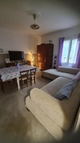 a living room with a couch and a table at Tana della Lavanda in Montefiorino