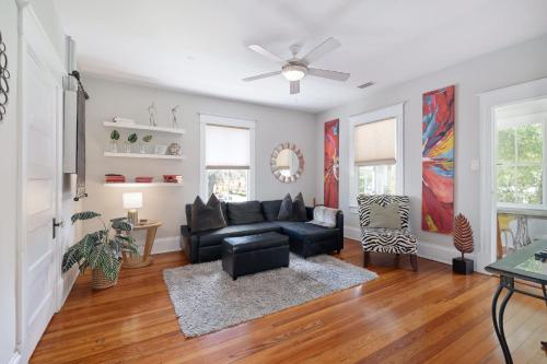 a living room with a couch and a ceiling fan at Old City Hideout l Historic l Walk to St George in St. Augustine