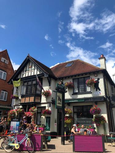 a large building with people sitting outside of it at Roof Garden @ No.60 High Street in Lyndhurst