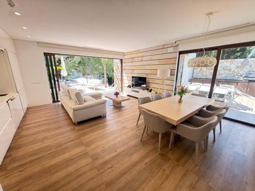 a living room with a dining room table and chairs at Las Colinas - 4 Bedroom Acacia Villa in Orihuela Costa