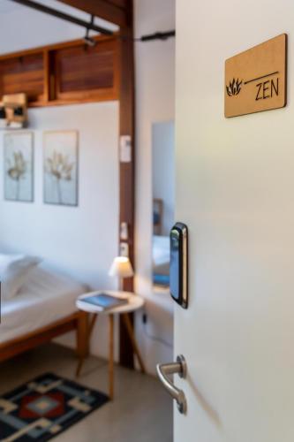 a room with a refrigerator and a desk at Contêiner 10 Hospedagem in Serra