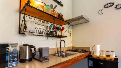 a kitchen with a sink and a counter top at Contêiner 10 Hospedagem in Serra
