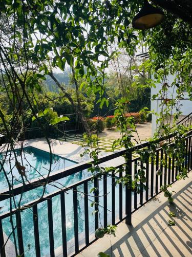 a view from a balcony of a swimming pool at Caravan holiday homes Vythiri in Vythiri