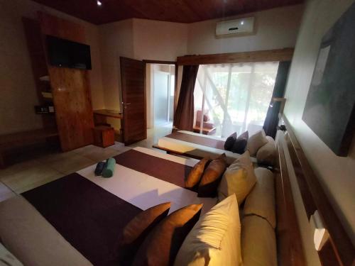 a living room with a couch and a window at Moringa Hotel in Toliara
