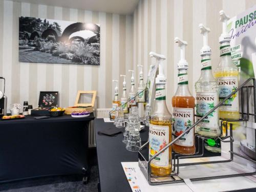 a display of bottles of beer on a bar at Hotel De Bourbon Grand Hotel Mercure Bourges in Bourges