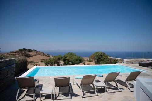 a group of chairs sitting next to a swimming pool at Melita home in Mesochórion