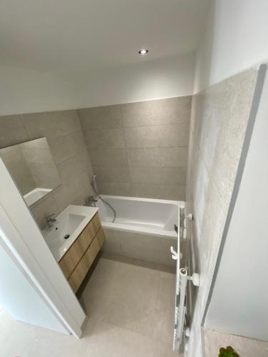 een badkamer met een wit bad en een wastafel bij Chalet Morets in Saint-Gervais-les-Bains