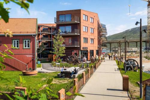 a street in a city with buildings and a sidewalk at Central studio apartment in Tromsø