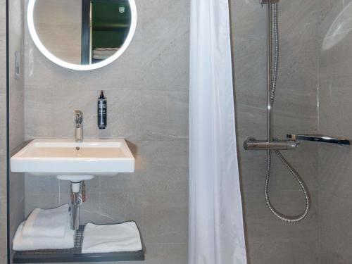 a bathroom with a sink and a shower at ibis Styles London Gatwick Airport in Crawley