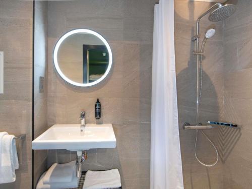 a bathroom with a sink and a shower with a mirror at ibis Styles London Gatwick Airport in Crawley