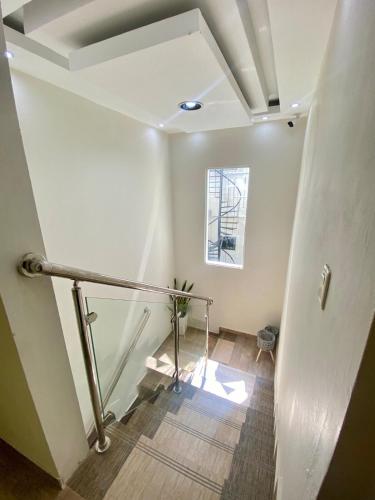 a hallway with a stair railing and a window at Our Home Zudelyn H8 in Los Frailes