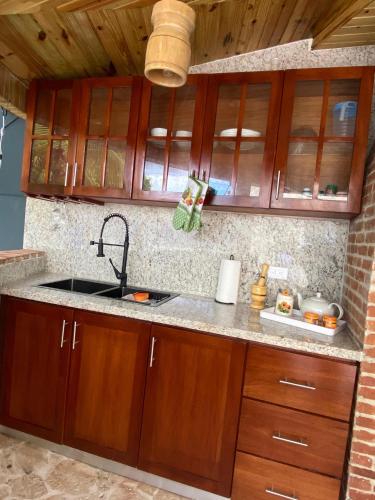 a kitchen with wooden cabinets and a sink at Our Home Zudelyn H8 in Los Frailes
