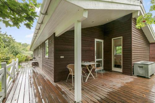 a wooden deck with a table on a house at K19045-Kalundborg-Lobelievej-3 in Kalundborg