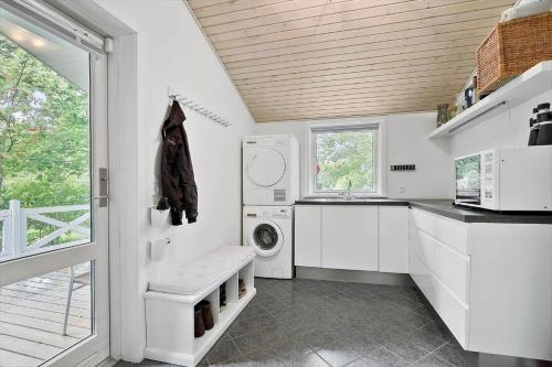 a white kitchen with a washer and dryer in it at K19045-Kalundborg-Lobelievej-3 in Kalundborg
