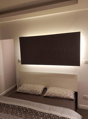 a bed with two pillows in a room at Calma house in Podgorica