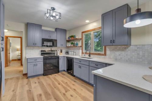 a kitchen with blue cabinets and white counter tops at Spacious 4BR Ranch Near Easton Perfect for Families & Work Groups in Parks Mills