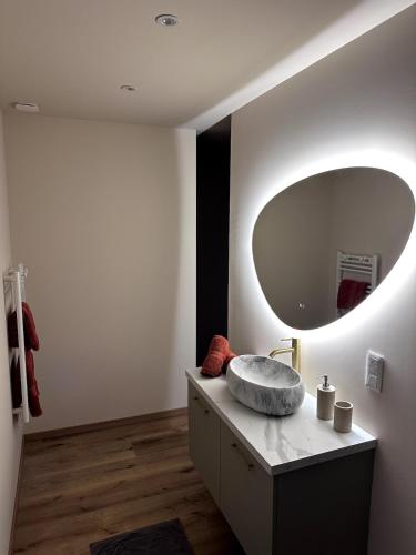 a bathroom with a sink and a large mirror at The Ponote Escape in Le Puy en Velay