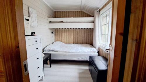 a small bedroom with a bed and a window at Messlingen, Orrstigen 16 in Funäsdalen