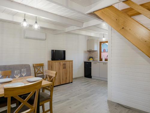 a kitchen and dining room with a table and chairs at Cicha Przystań w Jezierzanach in Jarosławiec