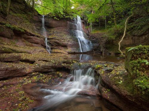 a waterfall in the middle of a river at 4 Bed in Ystradgynlais BN343 in Ystalyfera