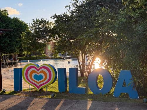a sign that says i love in front of a lake at Iloa resort AP luxo in Barra de São Miguel