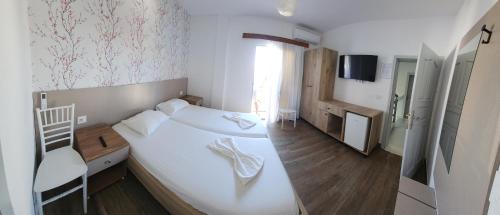 a bedroom with a large white bed and a chair at Villa2 in Golem