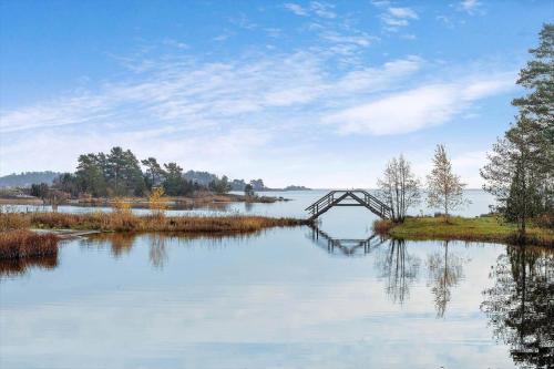 a bridge over a body of water with trees at OST559-Oskarshamn-Soervik-Elsemar-24 in Påskallavik