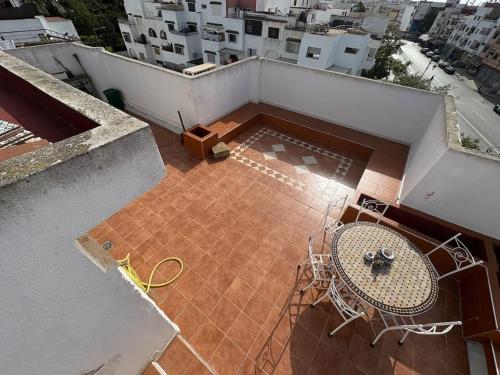an overhead view of a balcony with a table and chairs at Triplex of art and serenity in Kouas