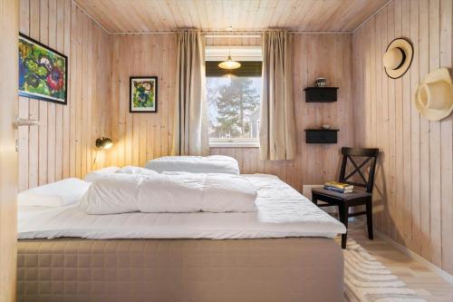 a bedroom with two beds and a window at 20125-Samso-Spaetmejsevej-2 in Nordby