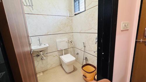 a bathroom with a toilet and a sink at Hotel swastik Inn in Ujjain