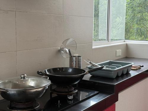 a kitchen counter with two bowls on top of it at ForestEdge bungalow 8BR 34pax Templer Villa in Rawang