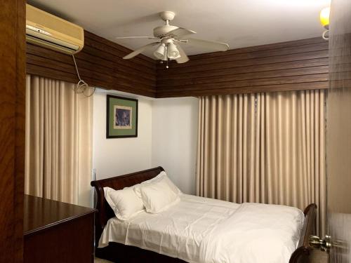 a bedroom with a bed and a ceiling fan at Khonikaloy 19 4BHK in Gulshan 2 near United Hospital in Dhaka
