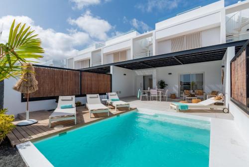 a villa with a swimming pool and a house at Villa Serena Blanca by Villalia Luxury Oasis & Private Pool in Playa Blanca