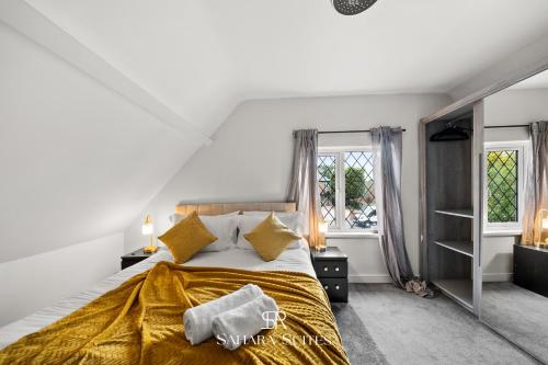 a bedroom with a bed with a yellow blanket and windows at Spacious 6BR - Woodley Stay - Sleeps 13 - Near City Hub - Parking in Woodley