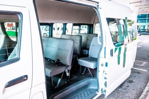 an open door of a white van with seats at Holiday Inn Mauritius Mon Trésor by IHG in Blue Bay
