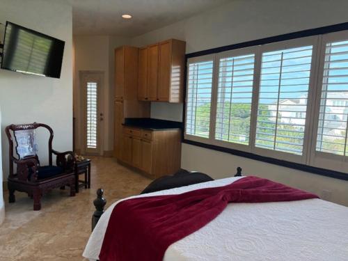 a bedroom with a large bed and a television in it at Bliss By The Sea in Saint Augustine