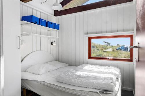 a bed in a small room with a window at TV1532-Skagen-Solbakken-55 in Skagen