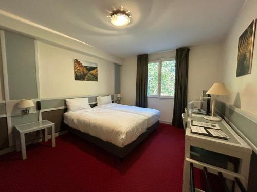Katil atau katil-katil dalam bilik di Hostellerie St Vincent