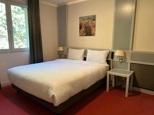 Katil atau katil-katil dalam bilik di Hostellerie St Vincent