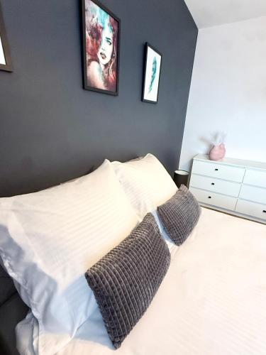 a bedroom with a white bed with two pillows at Loft Apartament 1 in Gorzów Wielkopolski