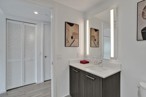 a bathroom with a sink and a mirror at Cadenza Miami - Luxury Residences in Miami