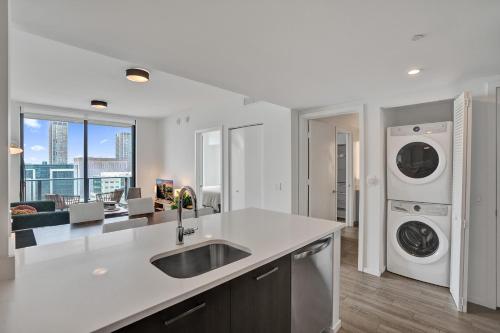 a kitchen with a sink and a washer and dryer at Cadenza Miami - Luxury Residences in Miami