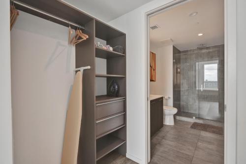 a bathroom with a walk in shower next to a toilet at Cadenza Miami - Luxury Residences in Miami