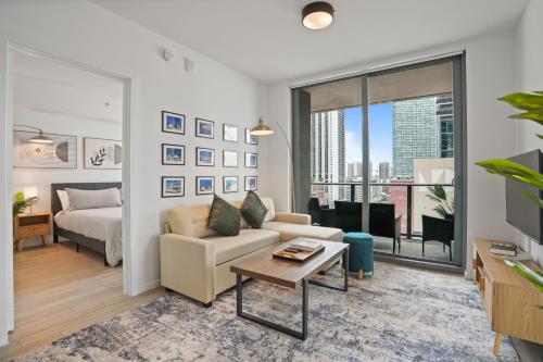 a living room with a couch and a bed at Cadenza Miami - Luxury Residences in Miami