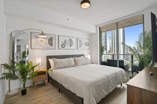 a bedroom with a bed and a large window at Cadenza Miami - Luxury Residences in Miami