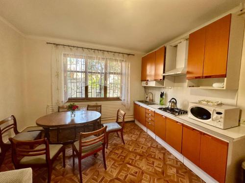 a kitchen with a table and a dining room at Amore in Zatoka
