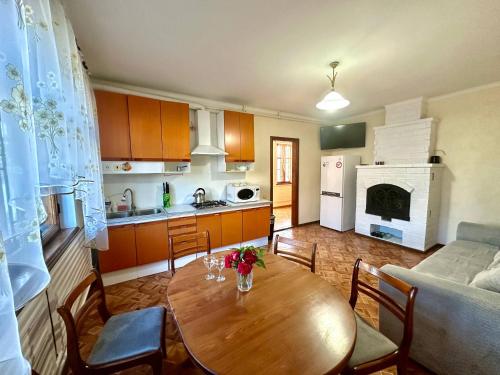 a kitchen and living room with a wooden table and chairs at Amore in Zatoka
