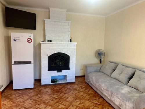 a living room with a couch and a fireplace at Amore in Zatoka